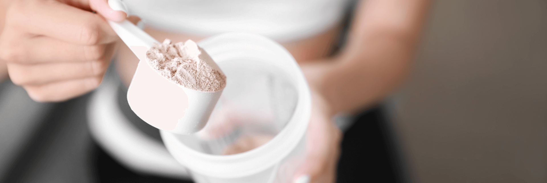 Woman making shake with poweder supplement